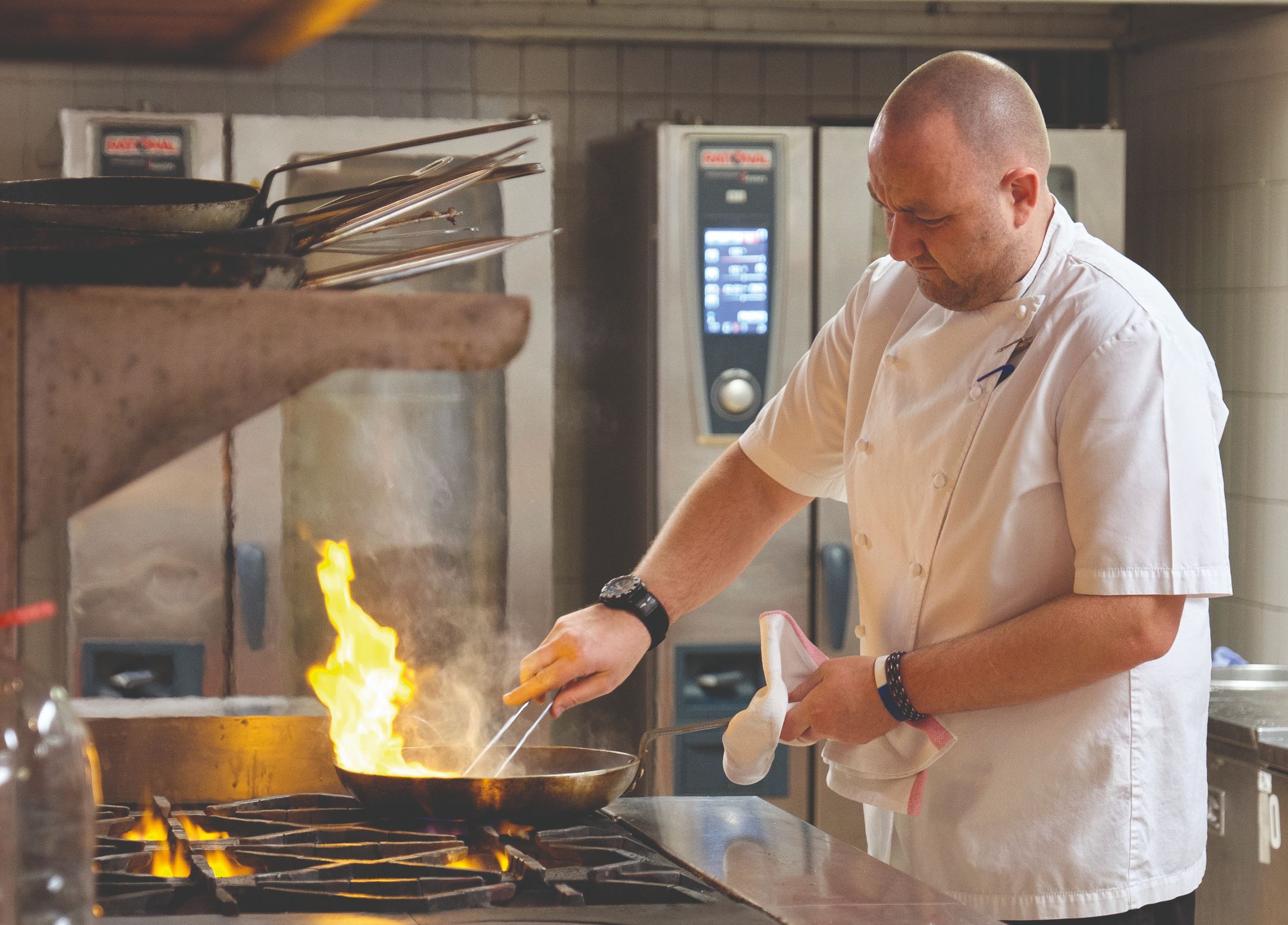 A chef is frying at high heat