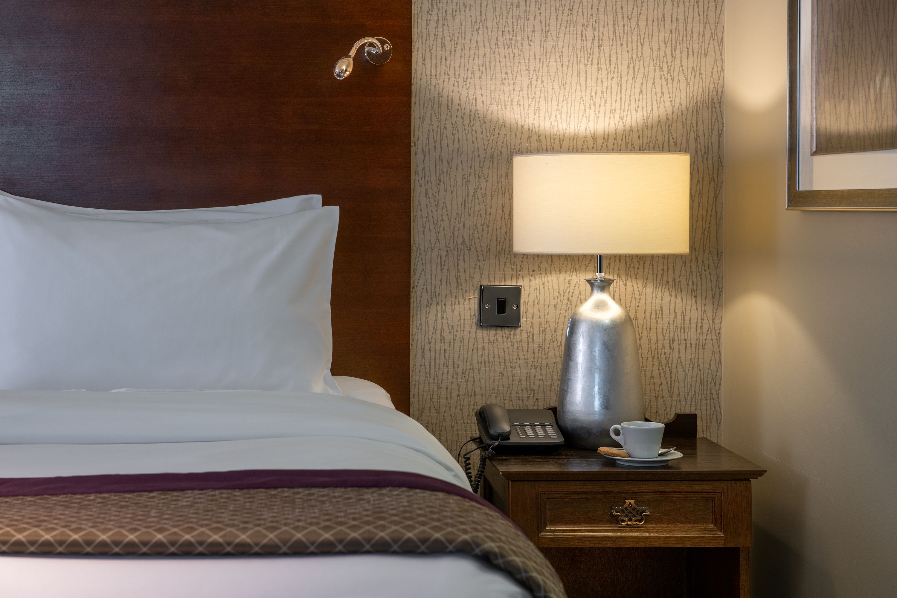 A view of the bed and bedside table