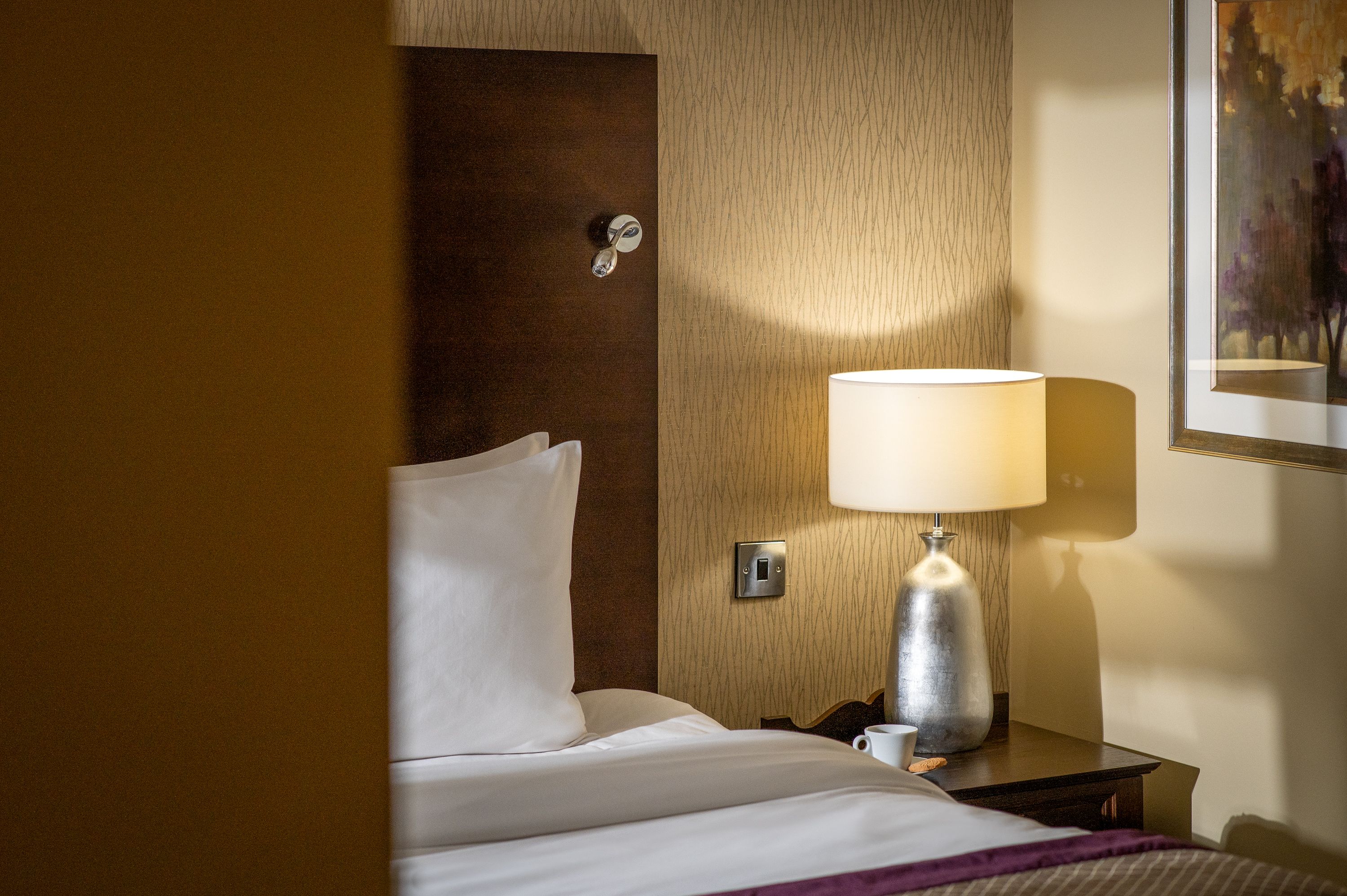 A view of the bed and bedside table