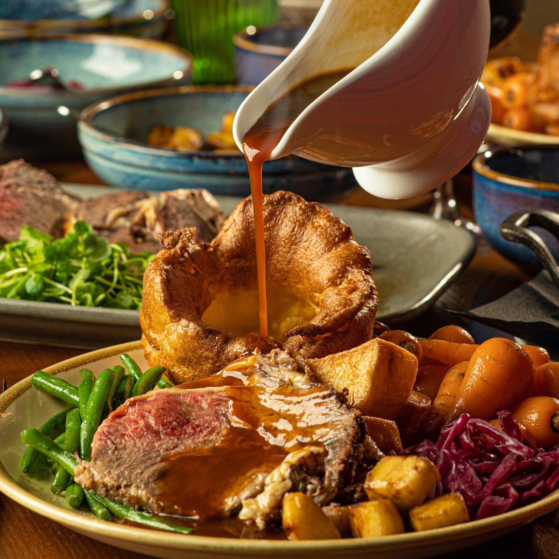 Gravy being poured on a roast